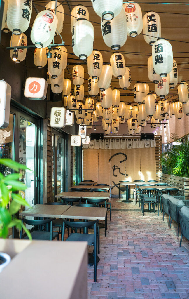 Paperfish Sushi Bar Terrace with white paper lanterns and Japanese characters